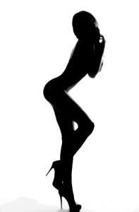 A naked woman poses in profile.